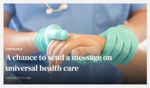 Image of a person in blue scrubs with a stethoscope around their neck, wearing green gloves, holding a patient's hand. With the words A chance to send a message on universal health care over the image.